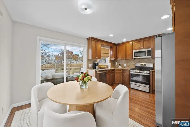 a kitchen with a table chairs stove and refrigerator