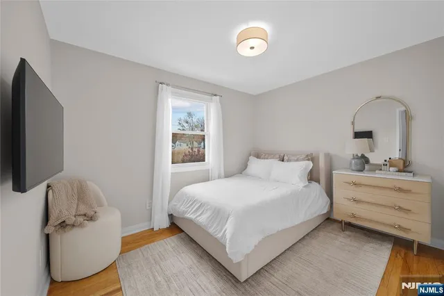 a bedroom with a bed and a mirror