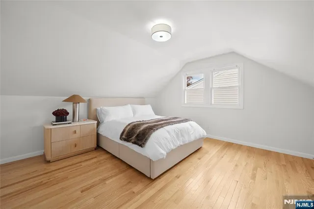 a spacious bedroom with a bed and a window