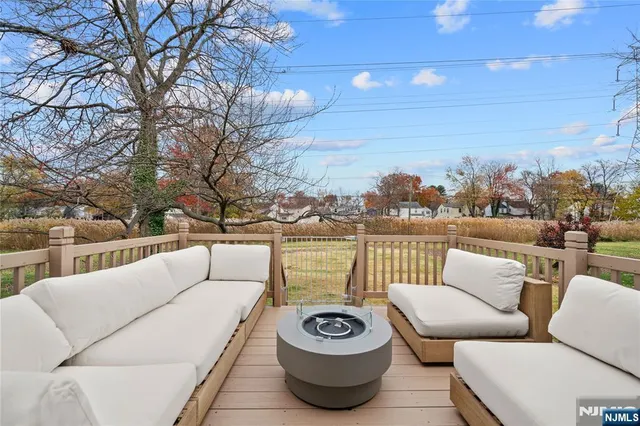 a view of a patio with couches and a large tree