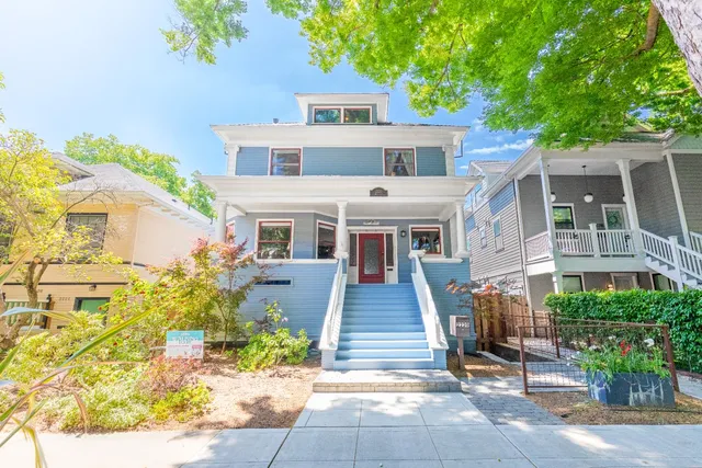 a front view of a house with a garden