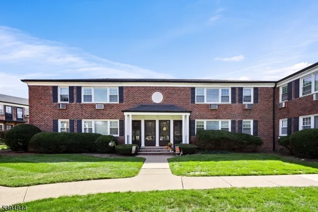 a front view of a house with yard and green space