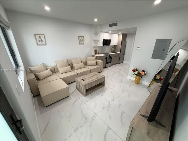 a living room with furniture and a flat screen tv