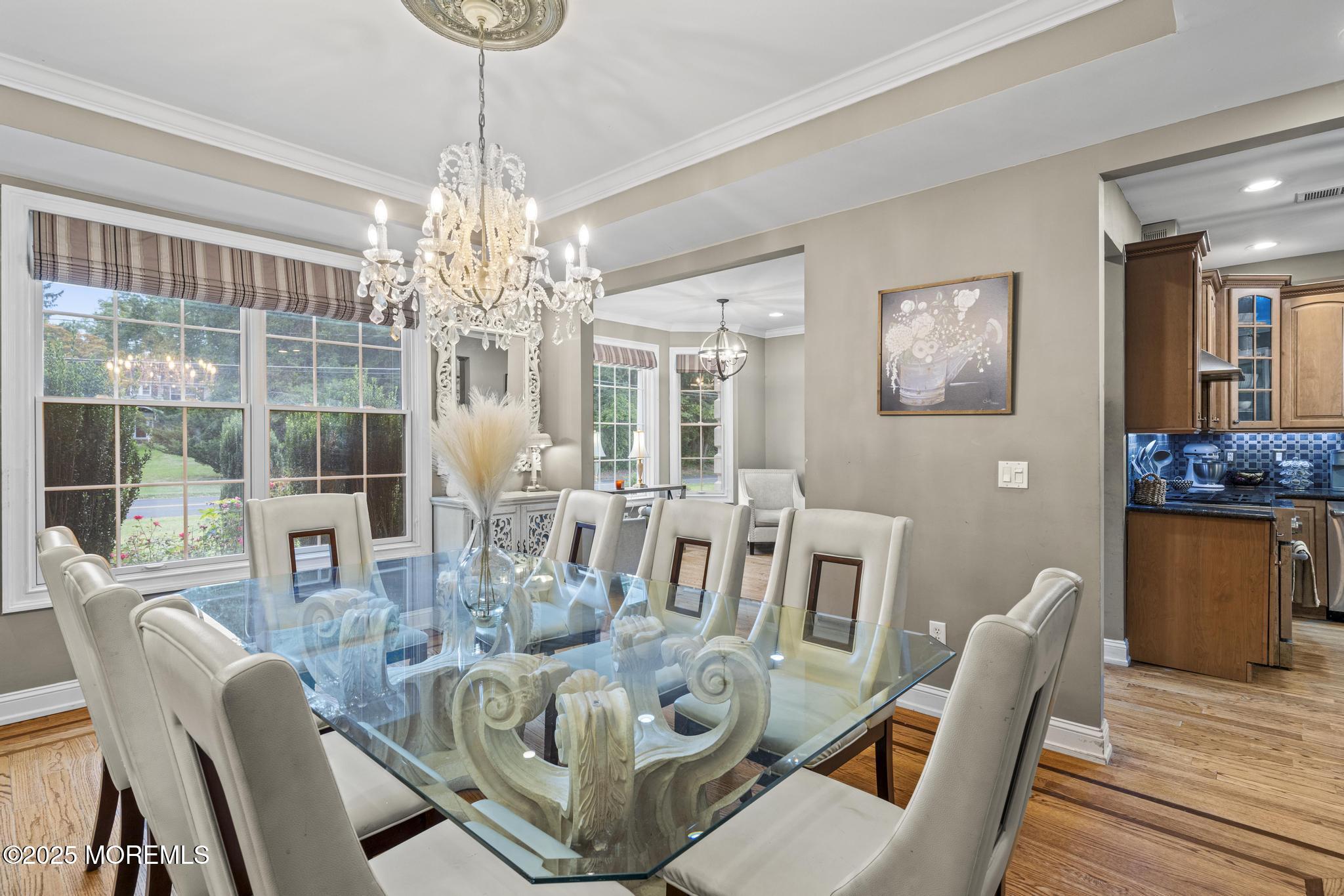 33 Harbor Road Morganville, NJ 07751 - Photo 13 of 49 a dining room with furniture a chandelier and wooden floor