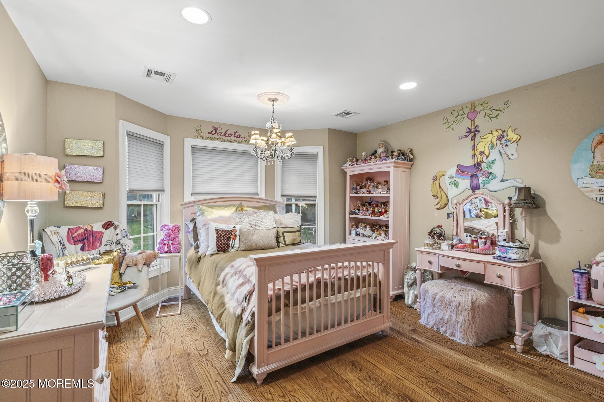 33 Harbor Road Morganville, NJ 07751 - Photo 33 of 49 a bedroom with furniture and a chandelier