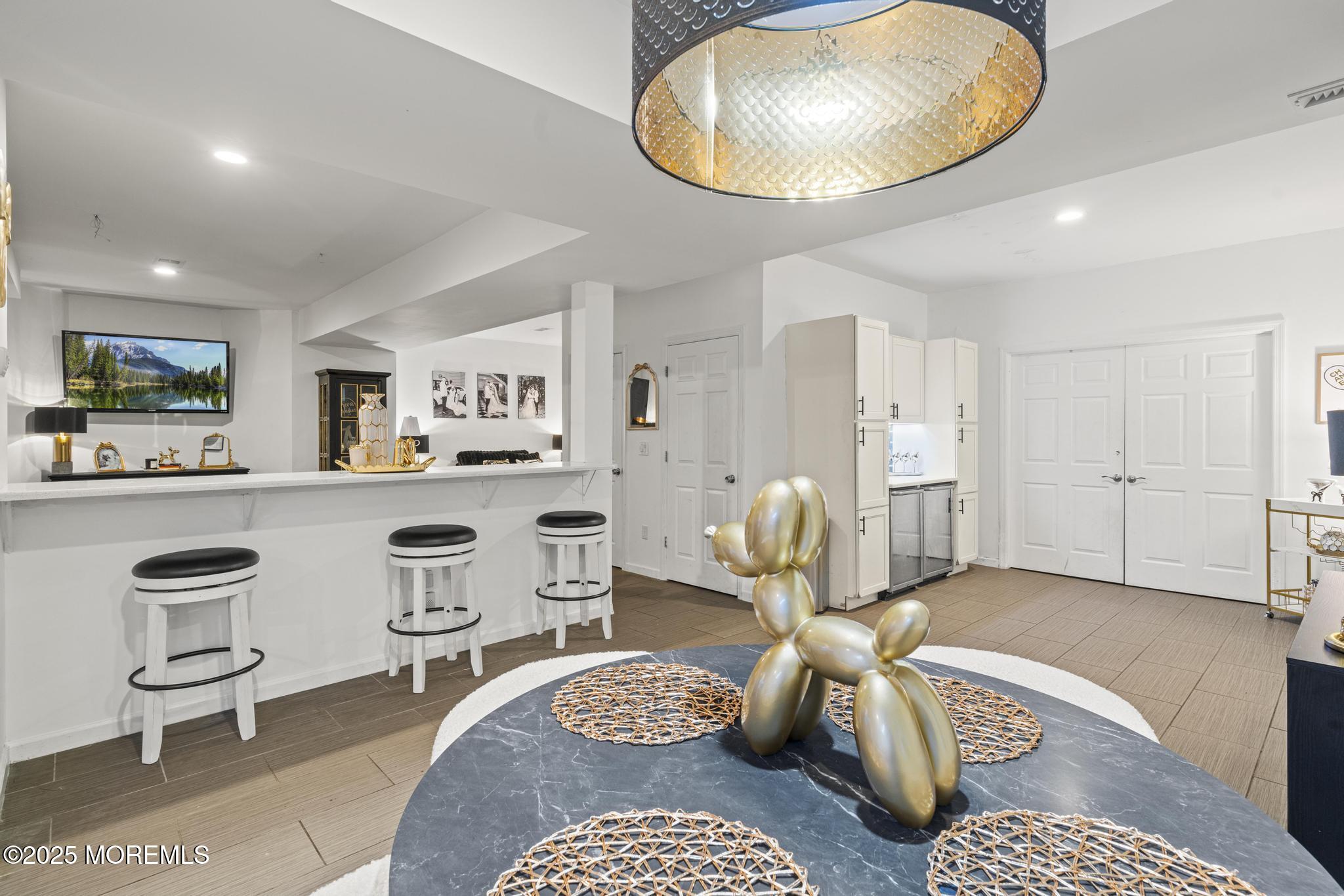 33 Harbor Road Morganville, NJ 07751 - Photo 44 of 49 a living room with furniture a rug and a chandelier