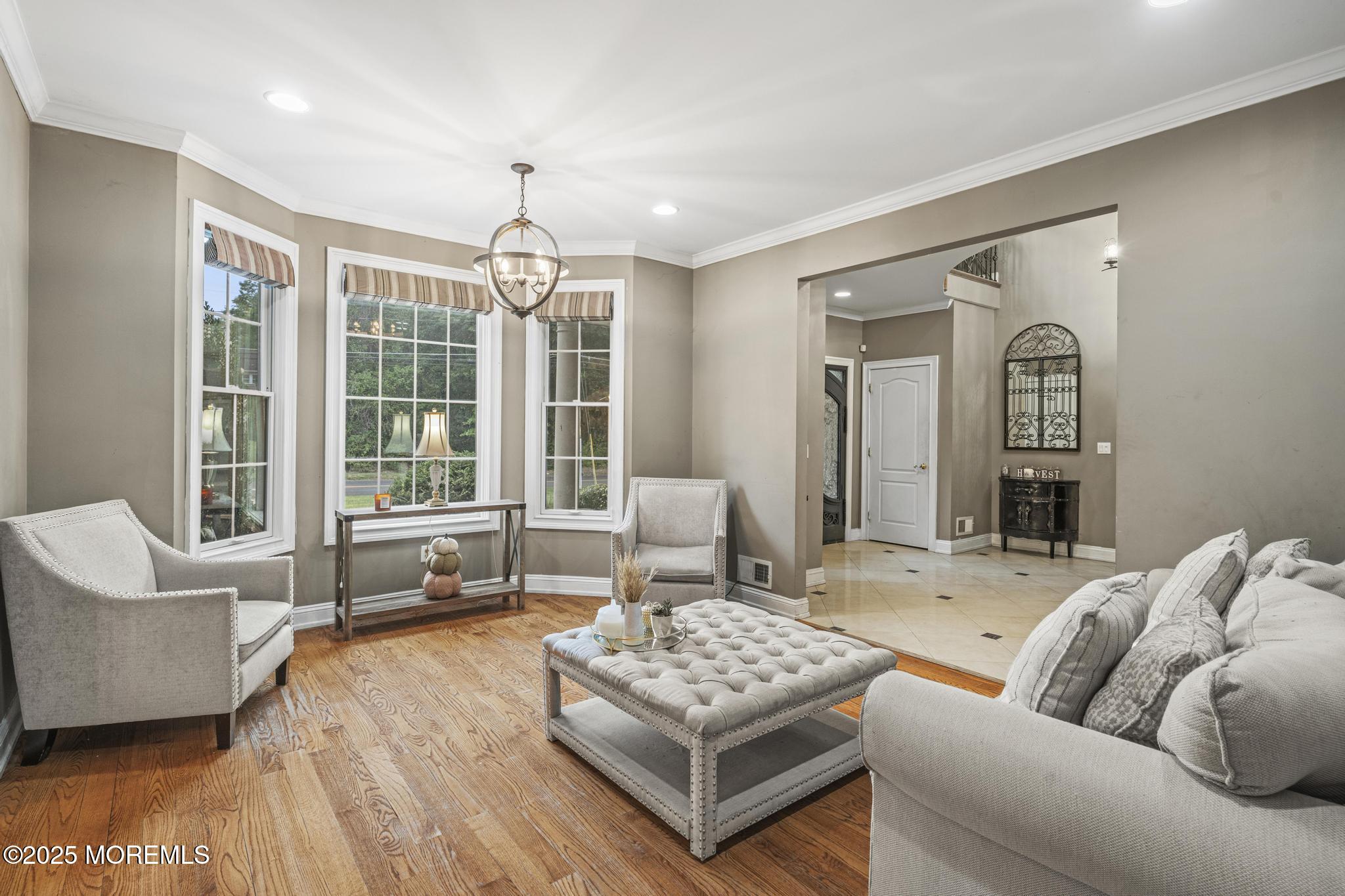 33 Harbor Road Morganville, NJ 07751 - Photo 9 of 49 a living room with furniture and a chandelier