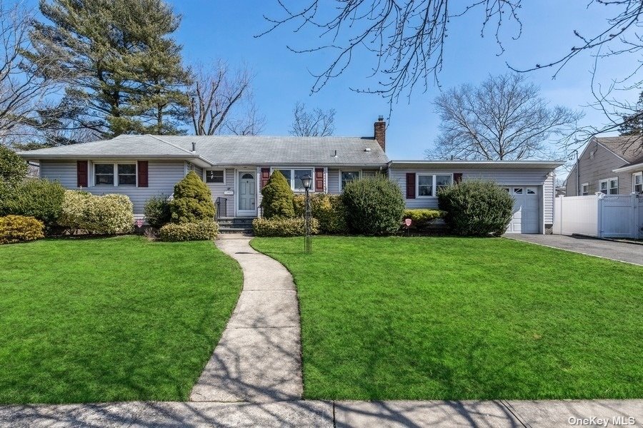 27 Chadwick Road Syosset, NY 11791 - Photo 1 of 1 a front view of a house with a yard