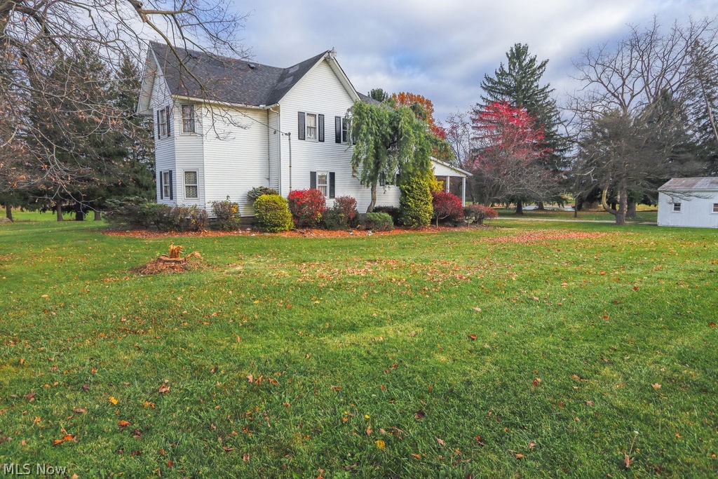 51883 Telegraph Road Amherst, OH 44001 - Photo 37 of 49 View of home's exterior featuring a yard
