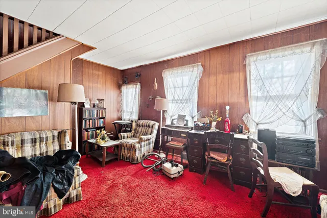 a room with furniture toys and a large window