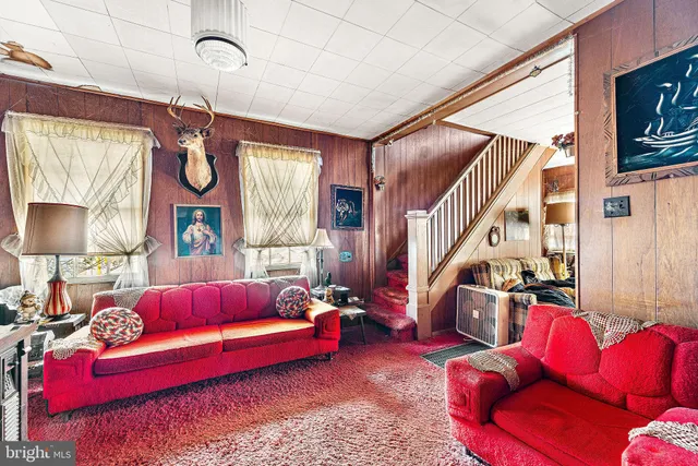 a living room with furniture or couch and a large window