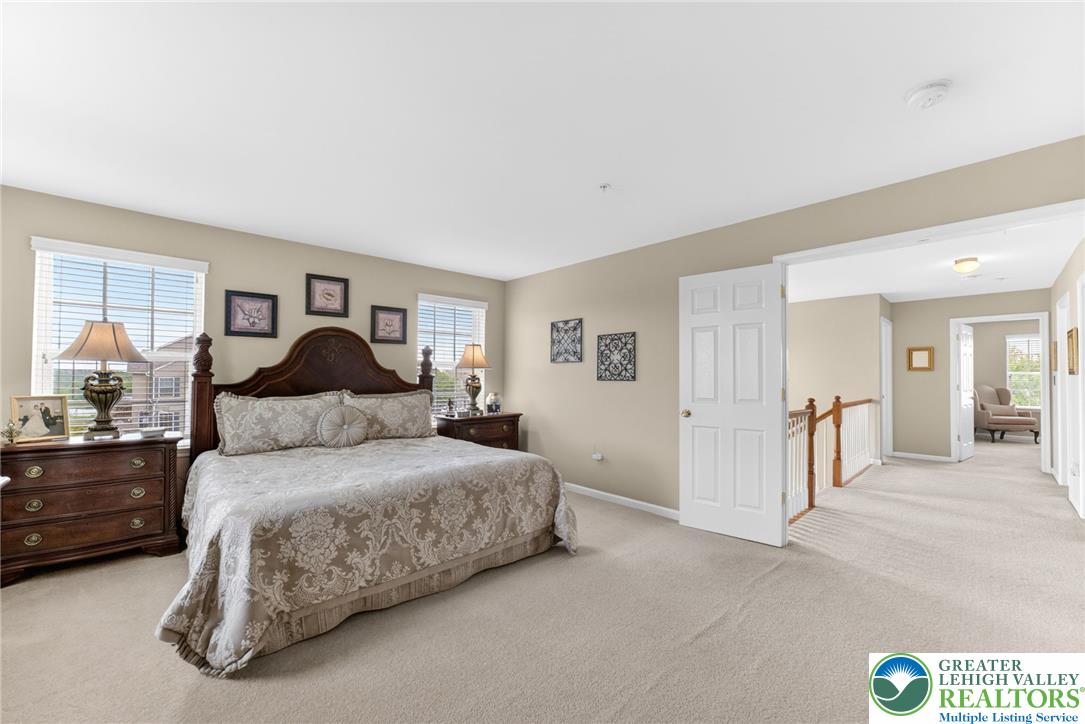 5440 Spring Ridge Drive West Macungie, PA 18062 - Photo 18 of 40 A tranquil primary bedroom with soft carpeting and well-lit windows for comfortable living.