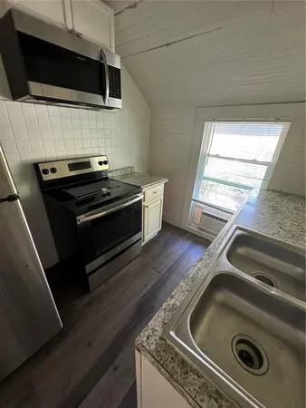 a stove top oven sitting inside of a kitchen