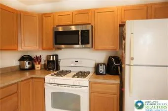 a view of a kitchen with a stove fridge and washer
