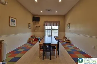 a dining room with furniture and window