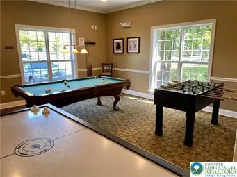 a room with furniture pool table and windows