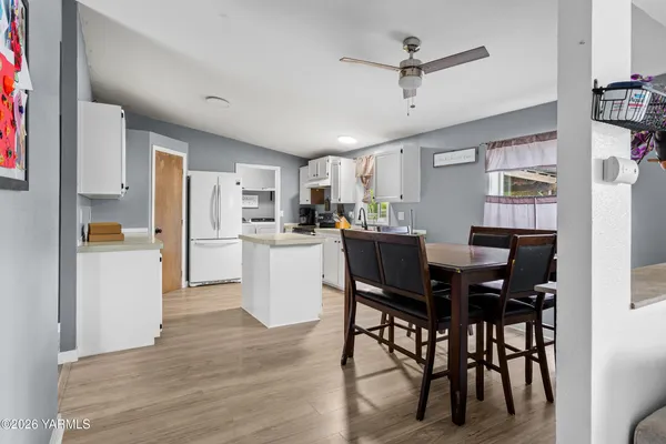 a view of a dining room with furniture and a kitchen