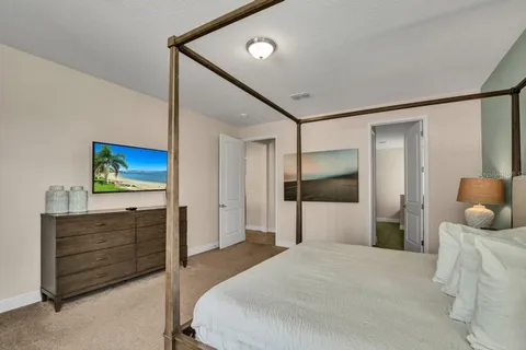 a bedroom with furniture and a flat screen tv