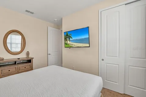 a bedroom with a bed and a mirror