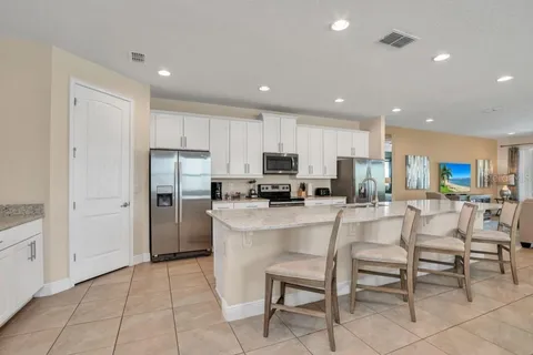 a kitchen with stainless steel appliances granite countertop a refrigerator and a stove top oven