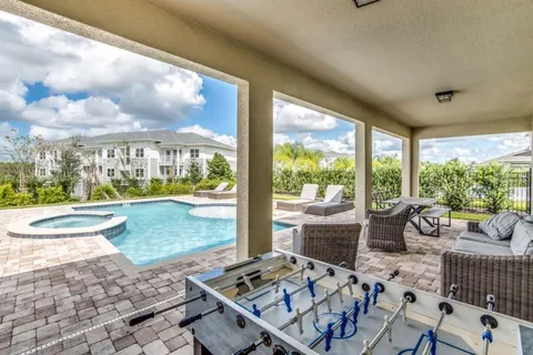 a living room with furniture and a floor to ceiling window