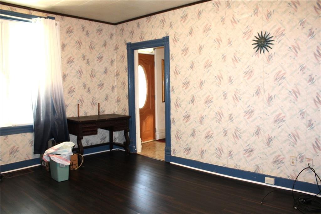 324 West North Street Butler, PA 16001 - Photo 13 of 42 a room with wooden floor and a door