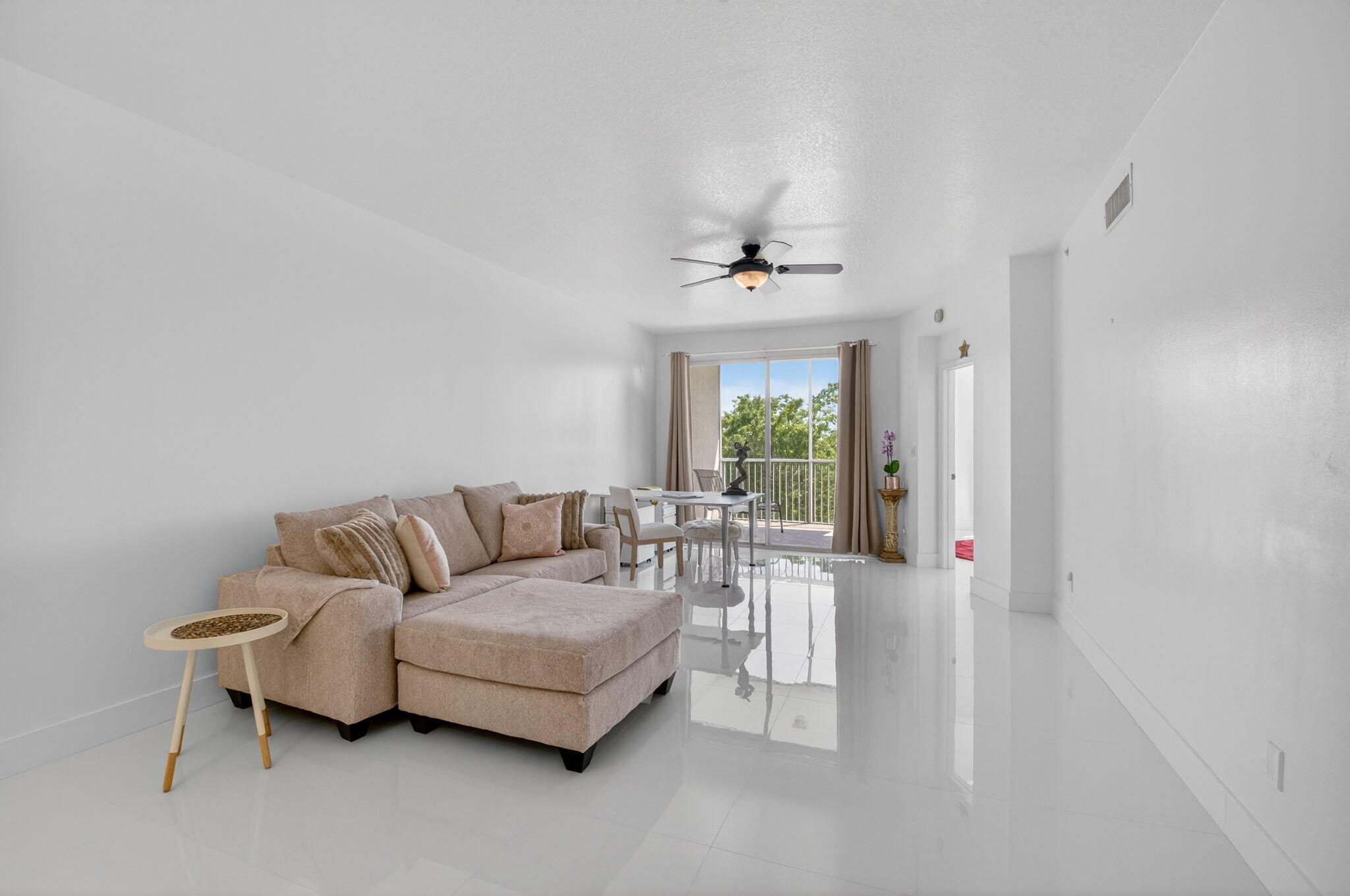 22703 Camino Del Mar, Unit 63 Boca Raton, FL 33433 - Photo 17 of 40 a living room with furniture and a large window