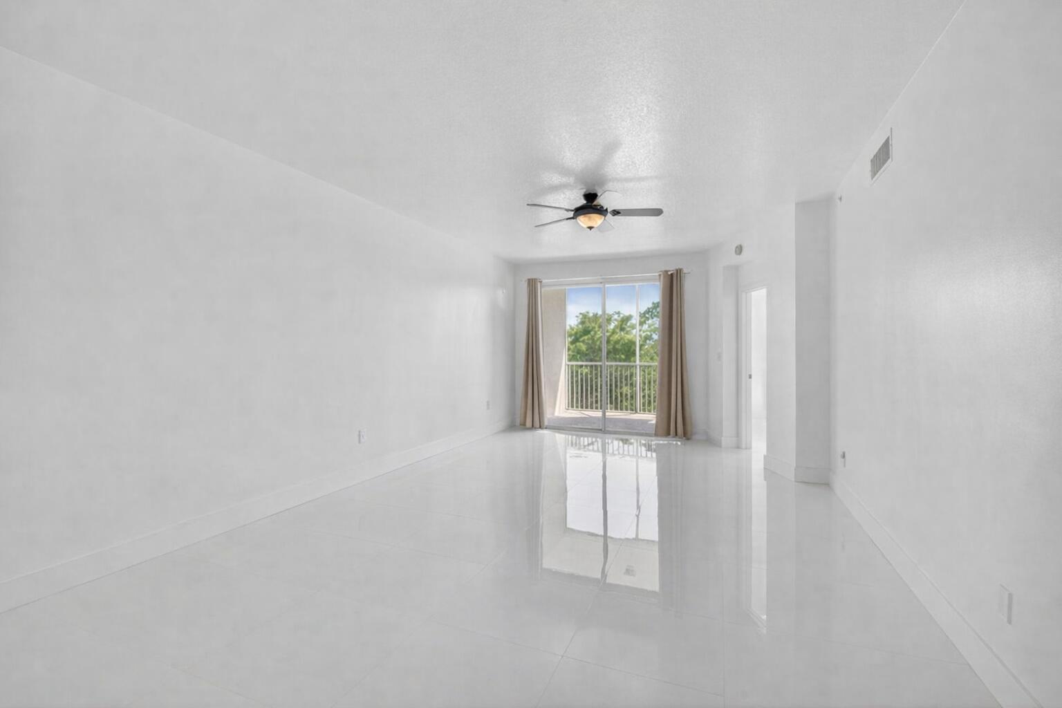 22703 Camino Del Mar, Unit 63 Boca Raton, FL 33433 - Photo 18 of 40 a view of an empty room with a window