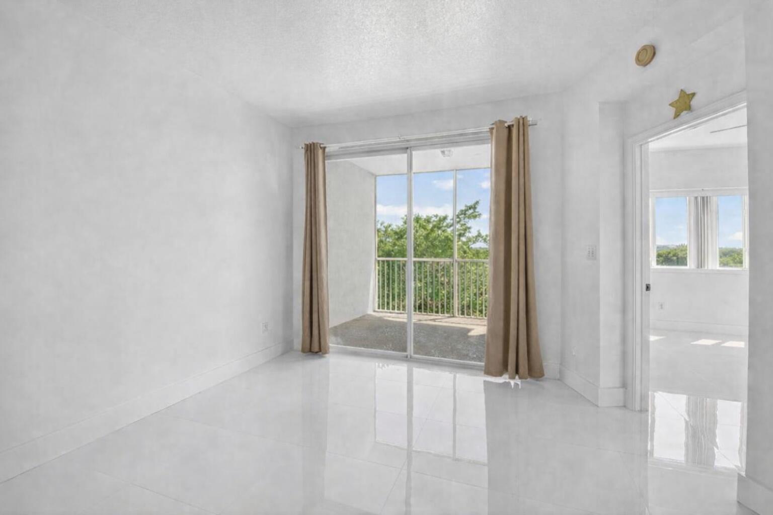 22703 Camino Del Mar, Unit 63 Boca Raton, FL 33433 - Photo 20 of 40 a view of an empty room with a window