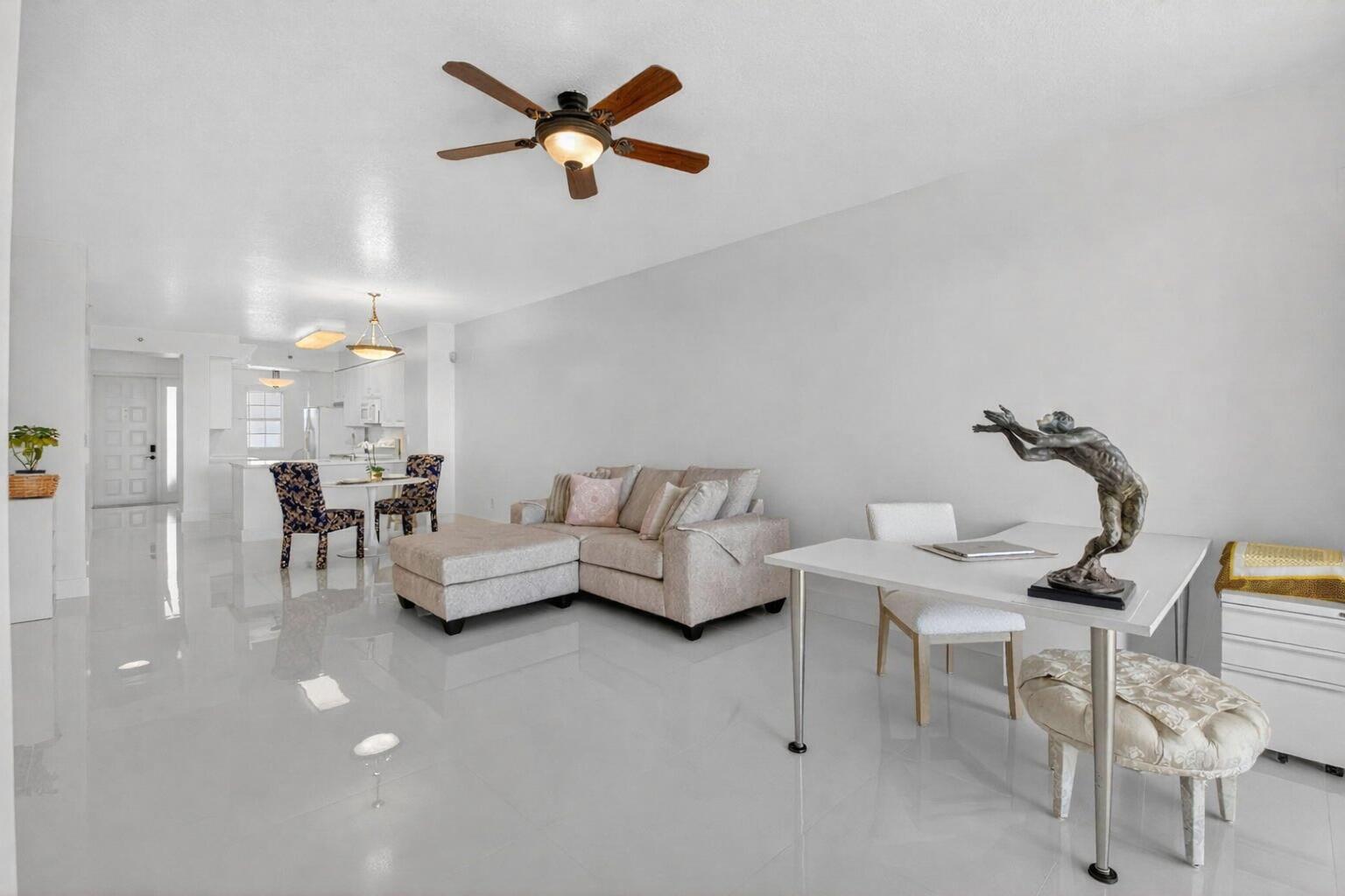 22703 Camino Del Mar, Unit 63 Boca Raton, FL 33433 - Photo 21 of 40 a living room with furniture and a chandelier