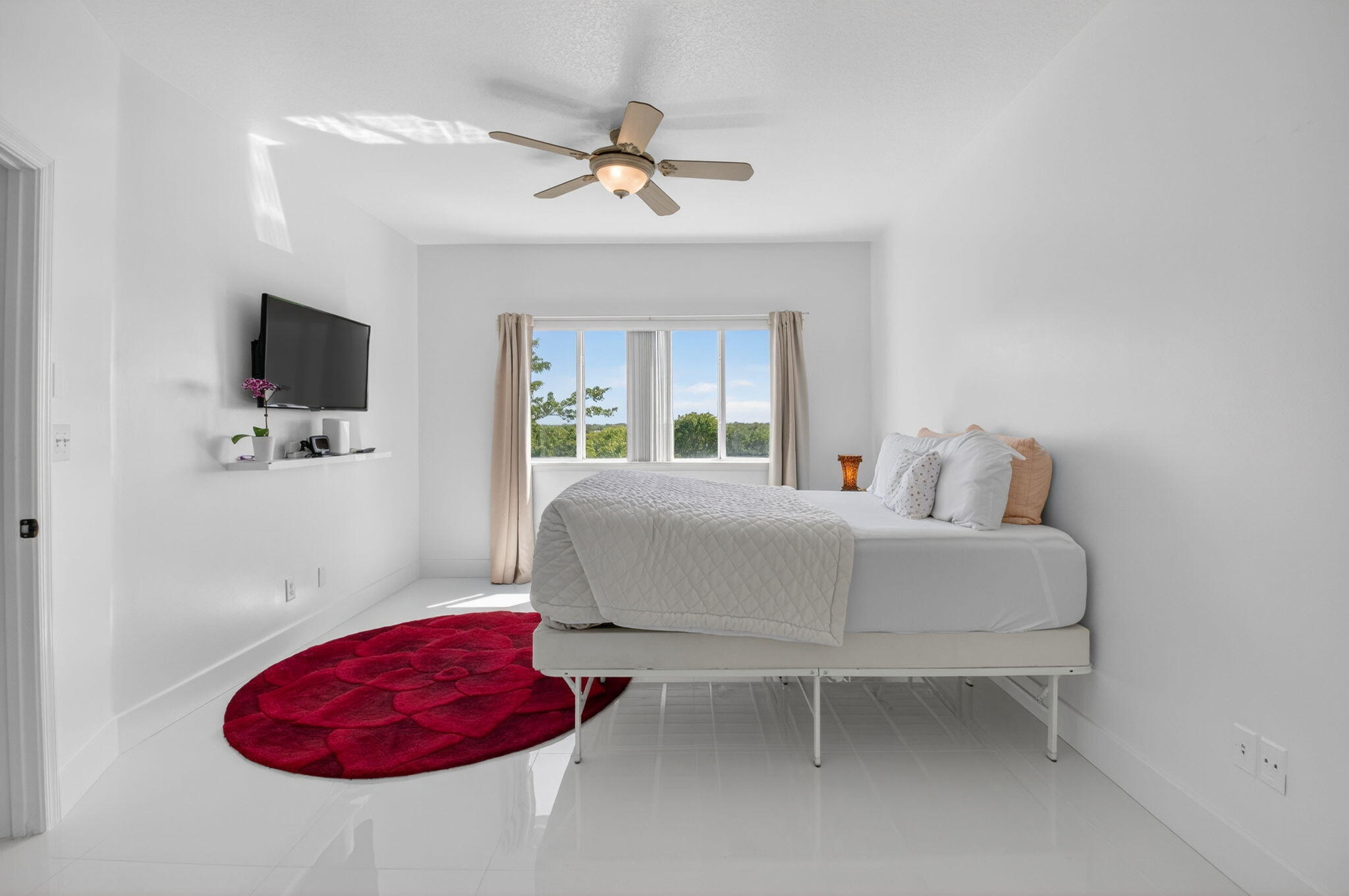 22703 Camino Del Mar, Unit 63 Boca Raton, FL 33433 - Photo 23 of 40 a bedroom with a bed and a flat screen tv