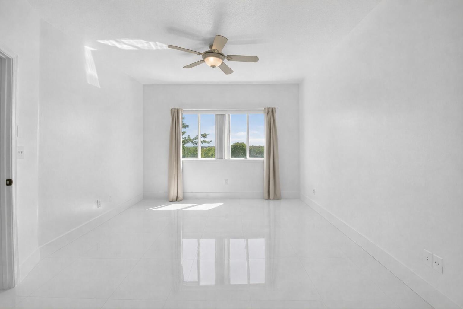 22703 Camino Del Mar, Unit 63 Boca Raton, FL 33433 - Photo 24 of 40 a view of a big room with chandelier fan and windows