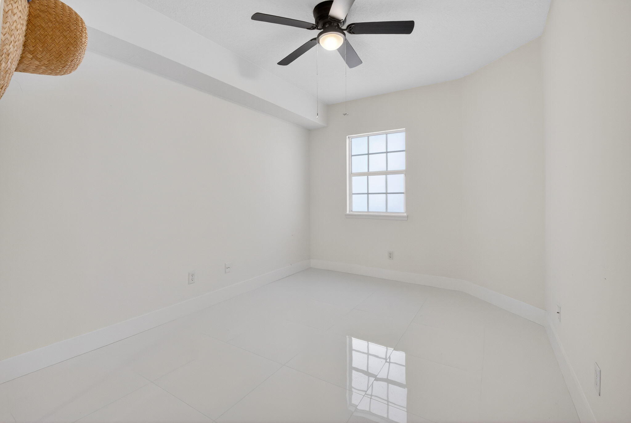 22703 Camino Del Mar, Unit 63 Boca Raton, FL 33433 - Photo 30 of 40 an empty room with a window and a ceiling fan