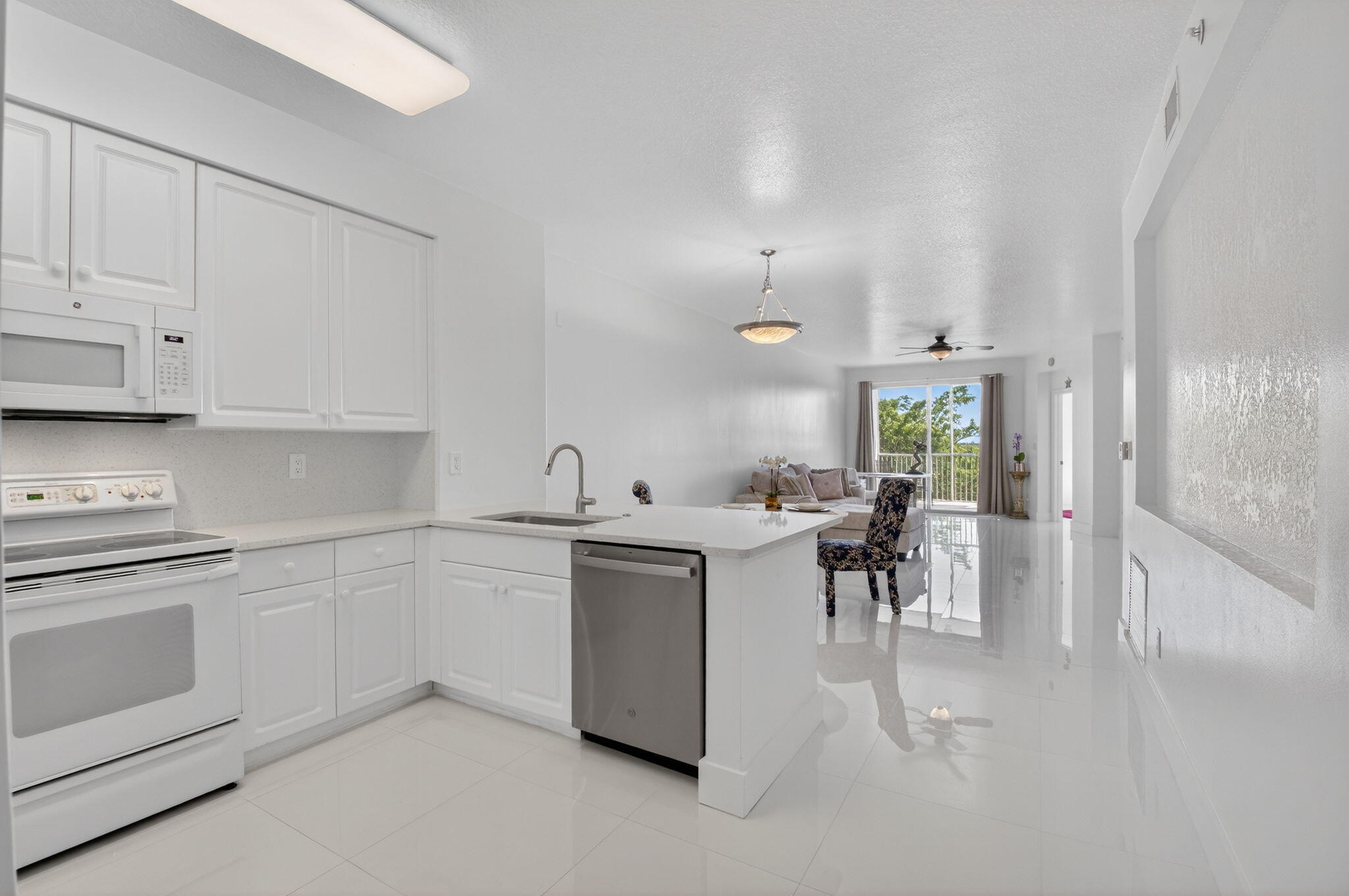22703 Camino Del Mar, Unit 63 Boca Raton, FL 33433 - Photo 8 of 40 a kitchen with a sink and cabinets