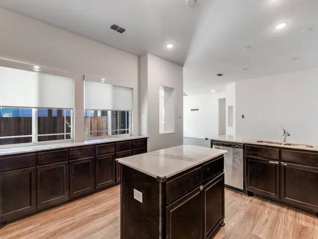 a kitchen with a stove sink and cabinets