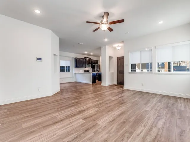 a view of a kitchen with a refrigerator and a stove top oven