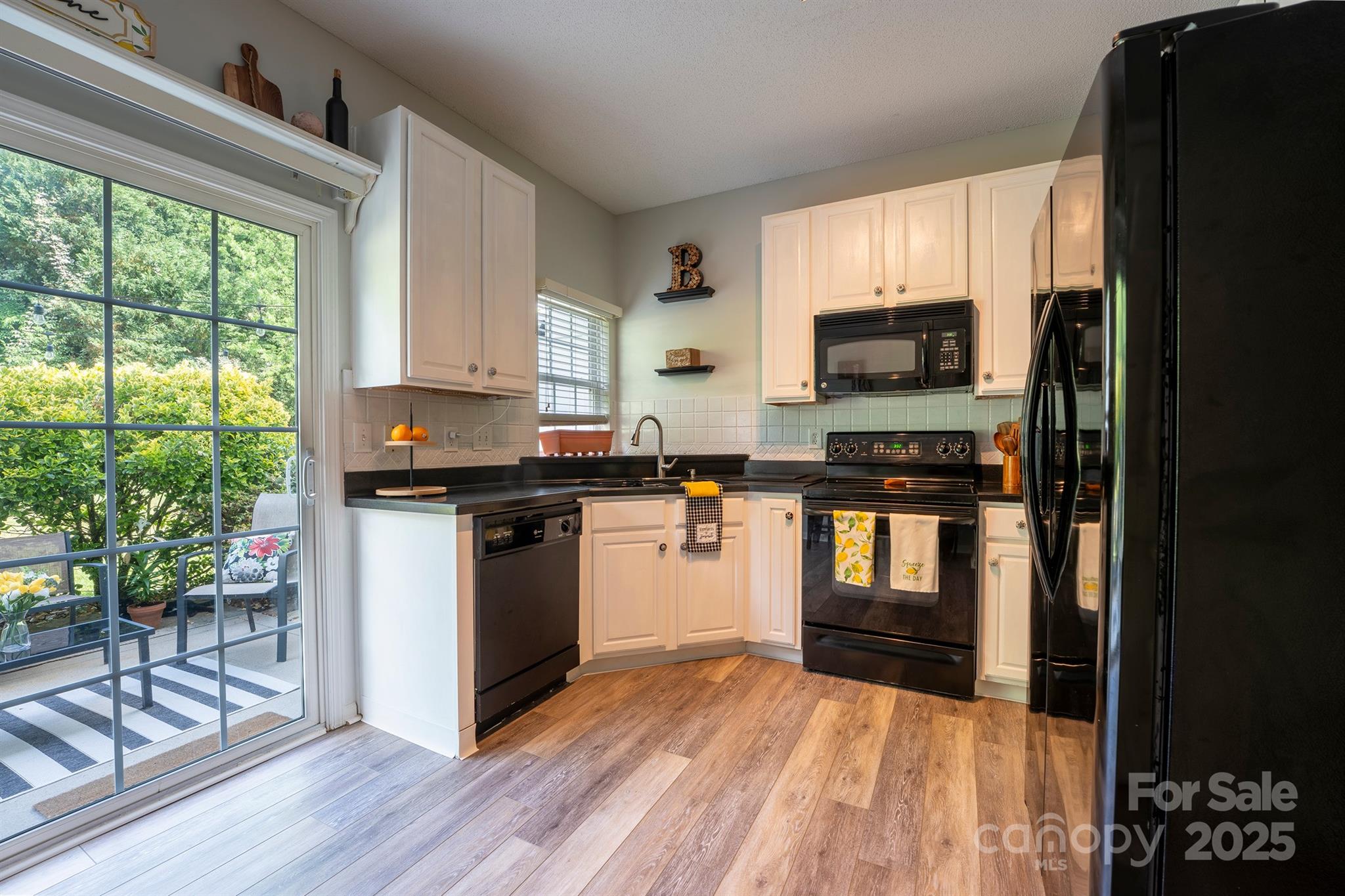3412 Summerfield Ridge Lane Matthews, NC 28105 - Photo 11 of 30 a kitchen with stainless steel appliances a stove top oven a sink dishwasher a refrigerator and a microwave oven
