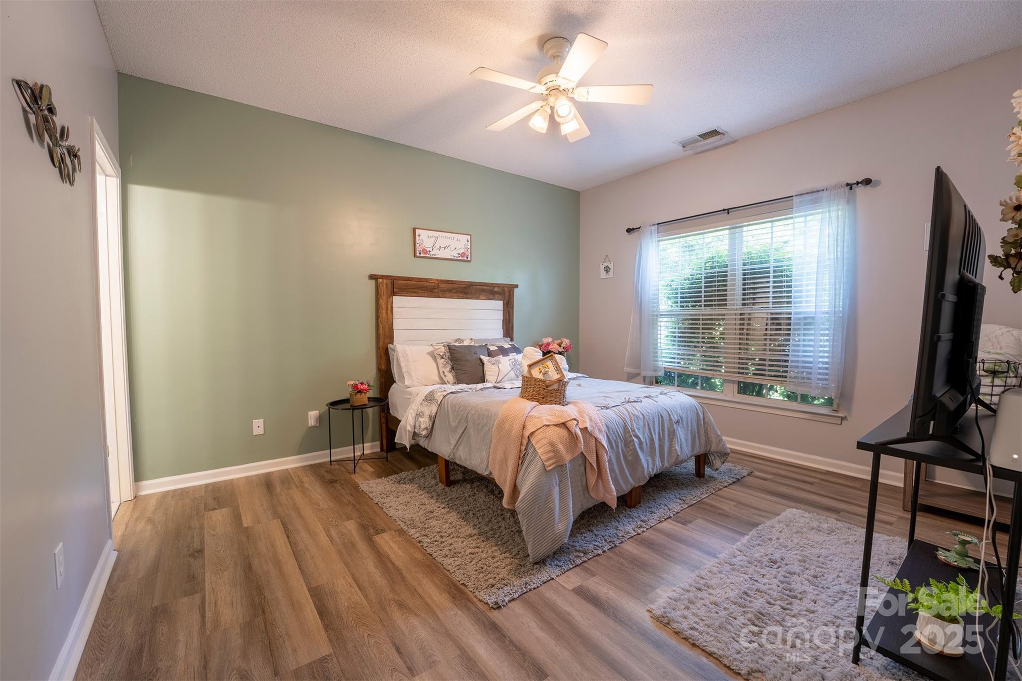 3412 Summerfield Ridge Lane Matthews, NC 28105 - Photo 13 of 30 a spacious bedroom with a bed and a flat screen tv