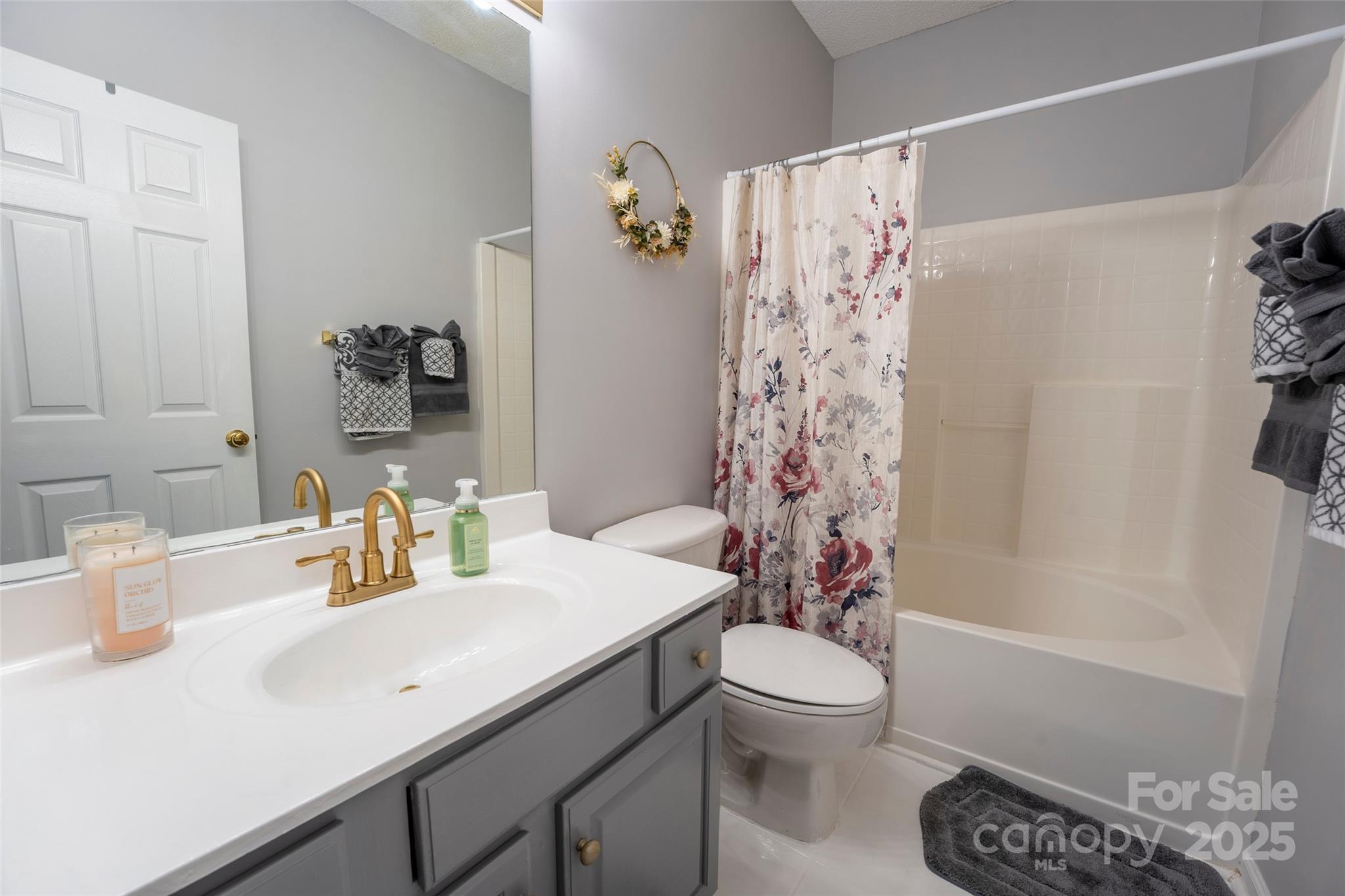 3412 Summerfield Ridge Lane Matthews, NC 28105 - Photo 15 of 30 a bathroom with a sink a toilet and shower curtain