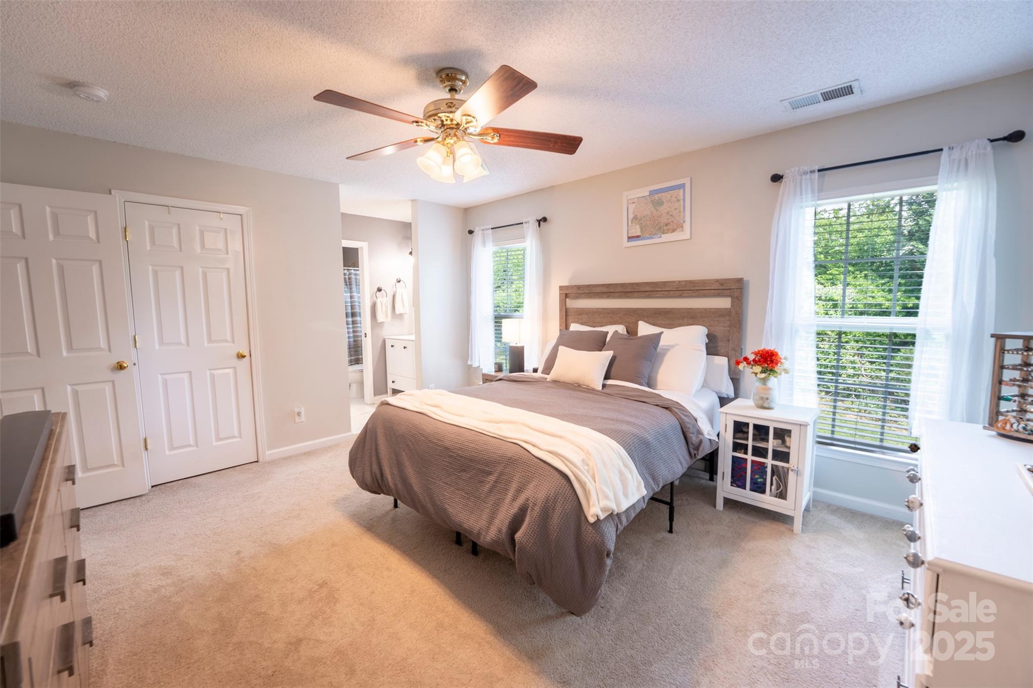 3412 Summerfield Ridge Lane Matthews, NC 28105 - Photo 21 of 30 a bedroom with a bed chandelier and a window