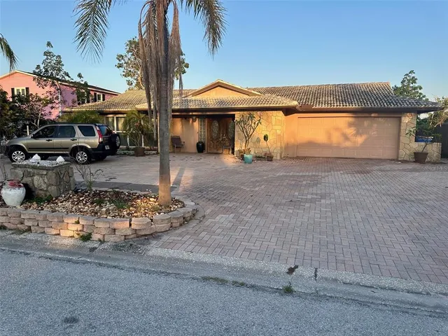 a front view of a house with a yard and parking space