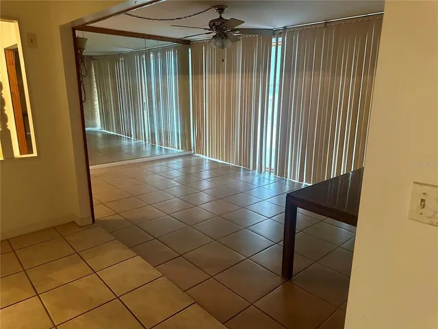 a view of a room with a large window and furniture