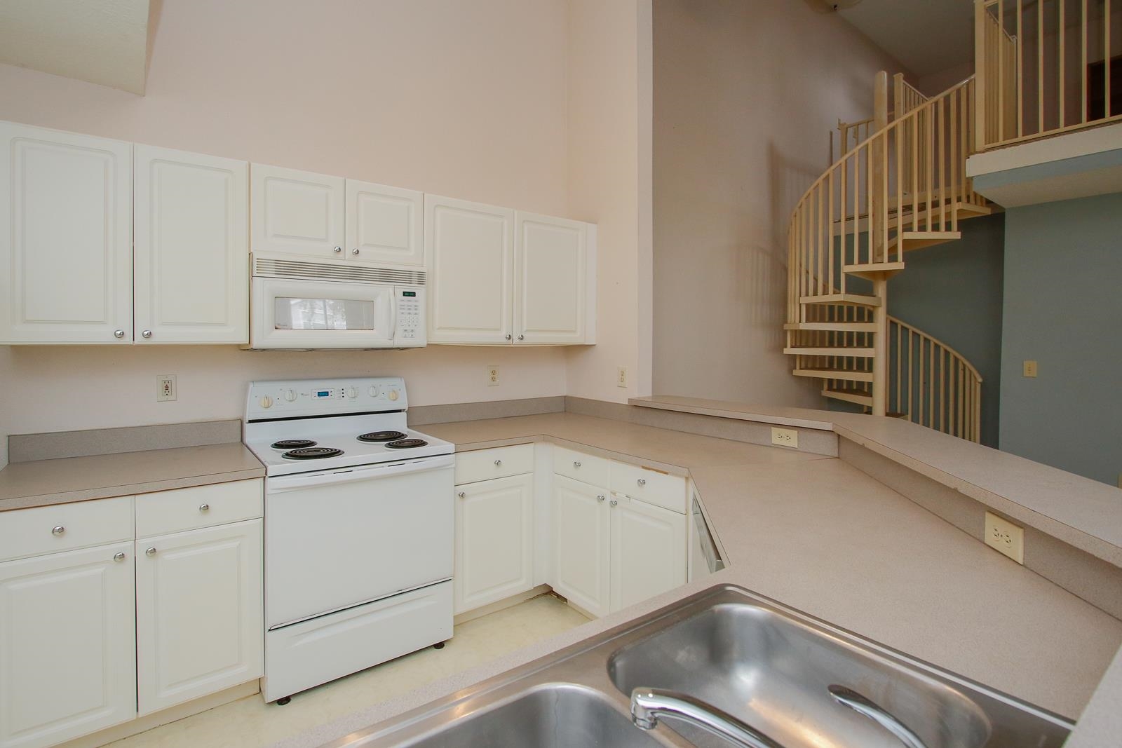 21201 Harbour Vista Circle St. Augustine, FL 32080 - Photo 12 of 43 a kitchen with white cabinets and appliances