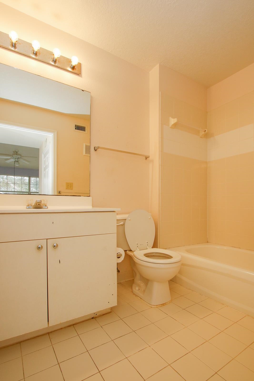 21201 Harbour Vista Circle St. Augustine, FL 32080 - Photo 18 of 43 a bathroom with a toilet a sink and mirror