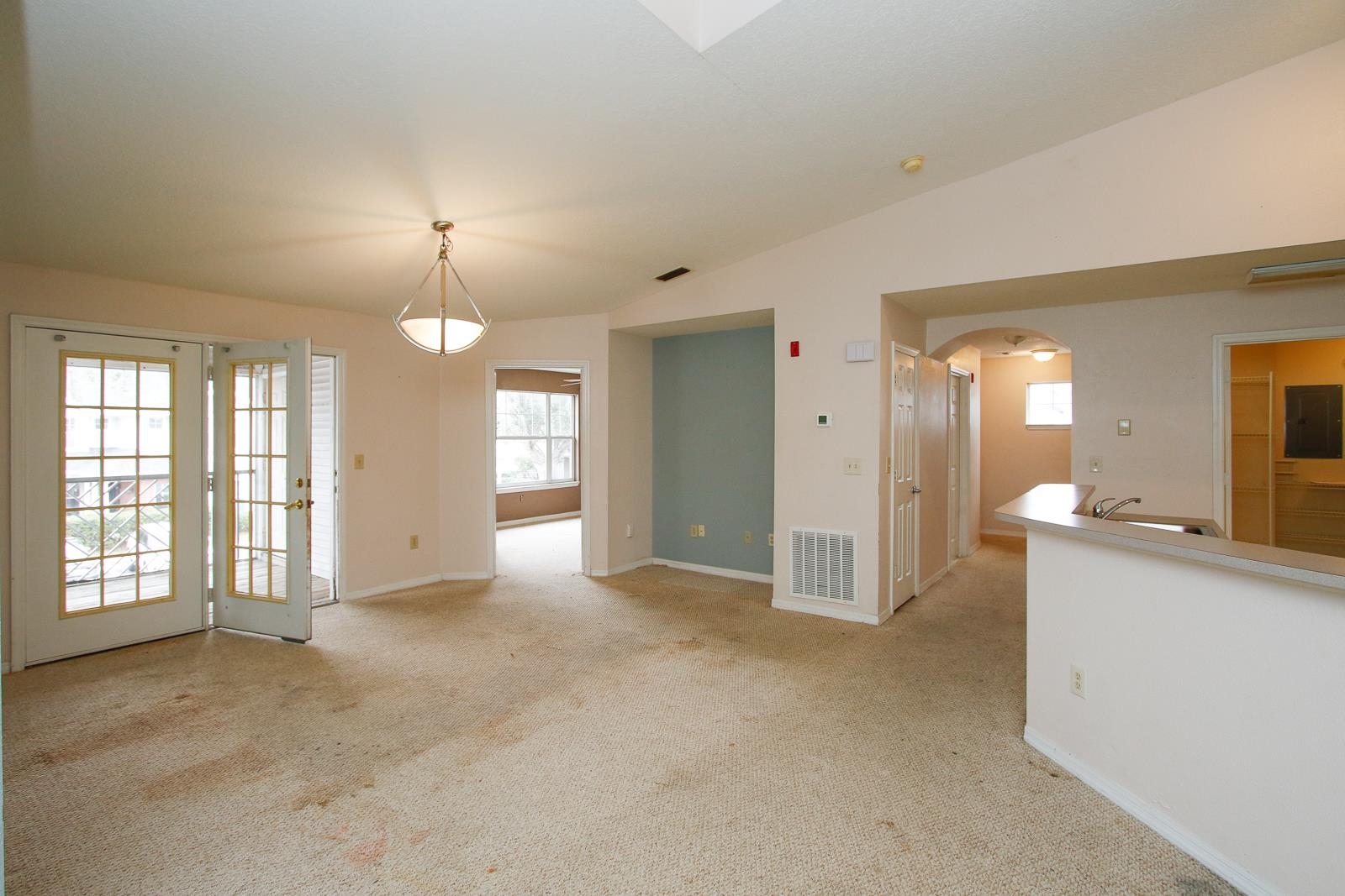 21201 Harbour Vista Circle St. Augustine, FL 32080 - Photo 6 of 43 an empty room with a kitchen and chandelier fan