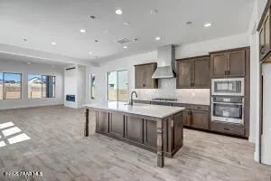 a kitchen with stainless steel appliances granite countertop a stove and a refrigerator