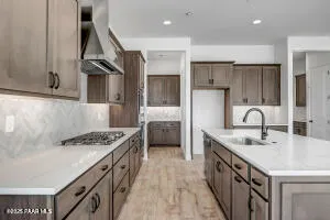a kitchen with stainless steel appliances granite countertop a sink stove and cabinets