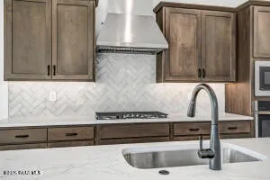 a kitchen with a sink and large window