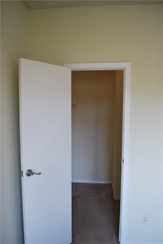 a view of a livingroom with wooden floor and a fireplace