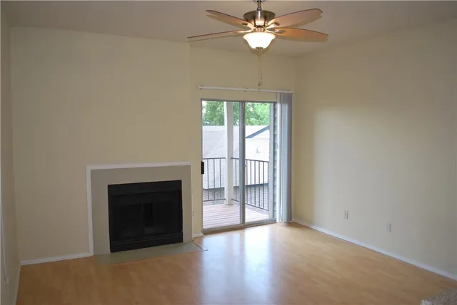 an empty room with windows fireplace